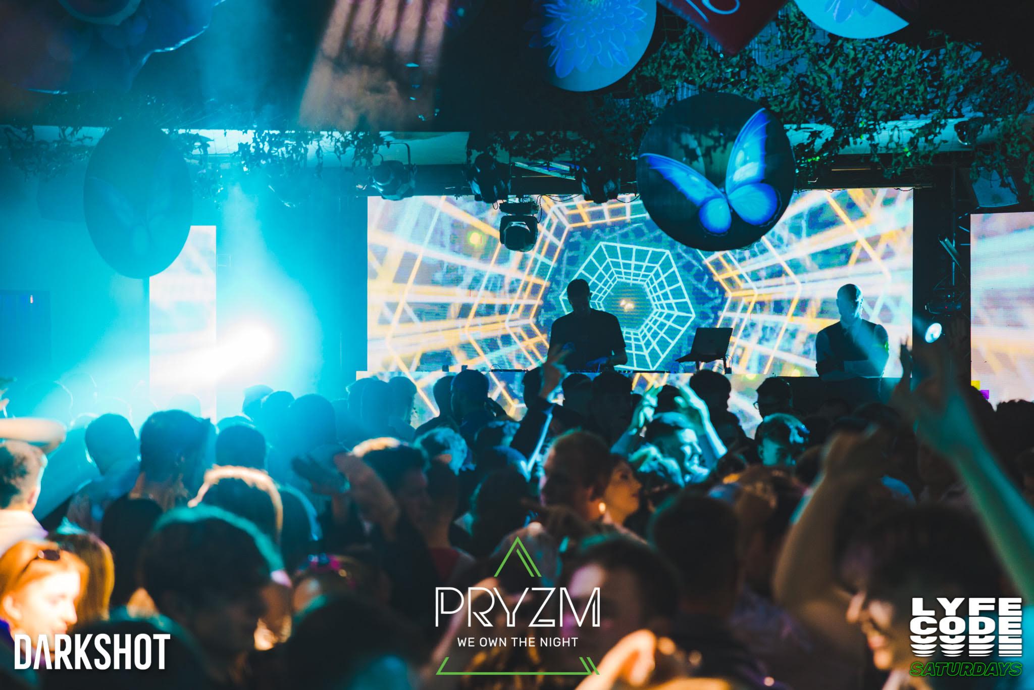 Live crowd watching large-scale geometric stage visuals